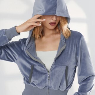 Photo d'une jeune femme portant un gilet à capuche en velours gris à demi-fermé