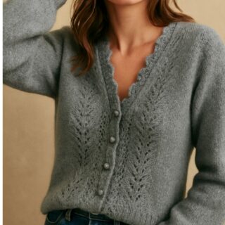 Gilet court en mohair ajouré gris perle, col festonné, boutons nacrés, porté avec un jean